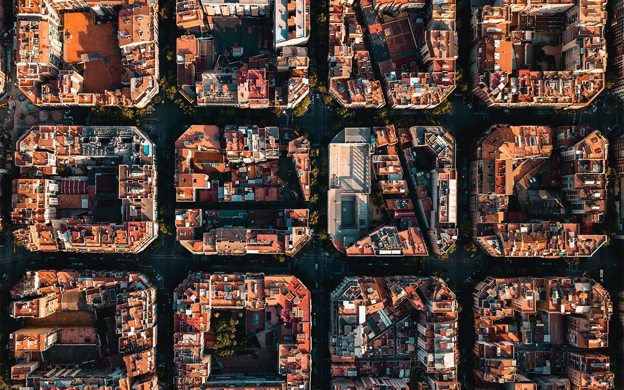 Aerial view of Barcelona's Eixample, a densely populated grid of residential and commercial mixed-use buildings